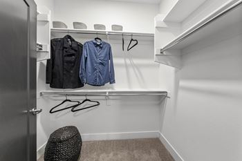 Large walk-in closets with wood shelving